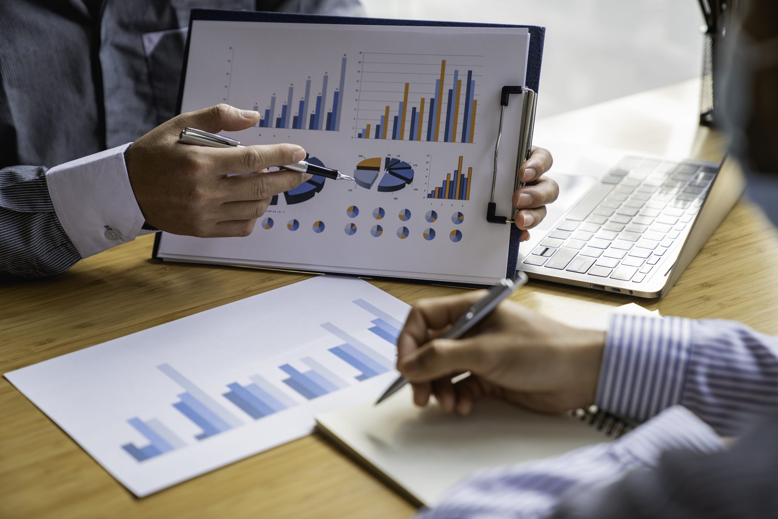 Business advisor analyzing financial figures denoting the progress Internal Revenue Service checking document. Audit concept