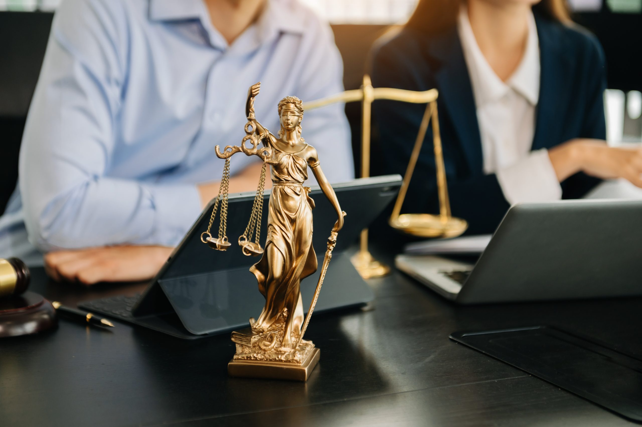 Business and lawyers discussing contract papers with brass scale on desk in office. Law, legal services, advice,  justice and law concept .
